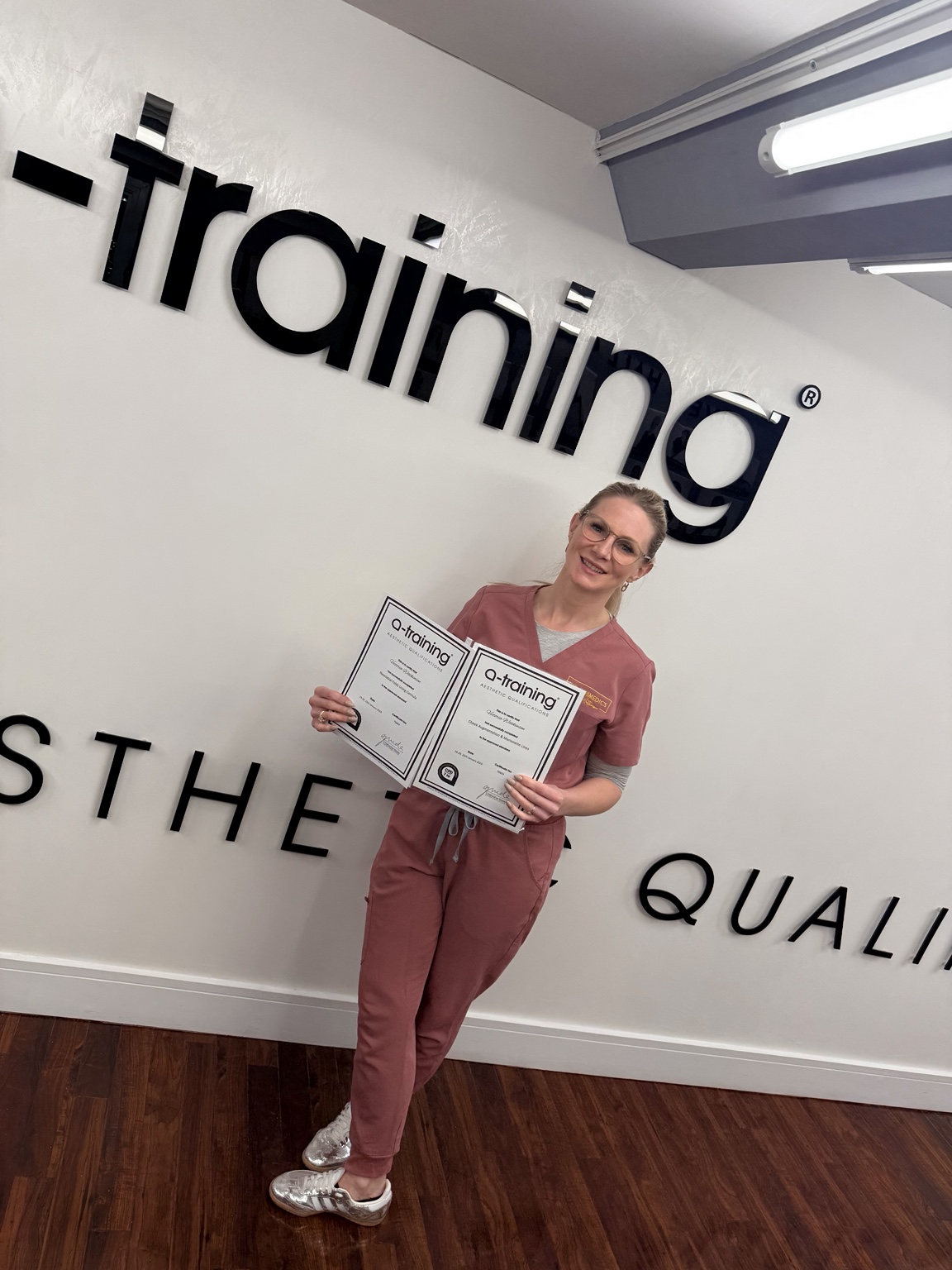 Victoria holding certificates following further aesthetic education at A-Training